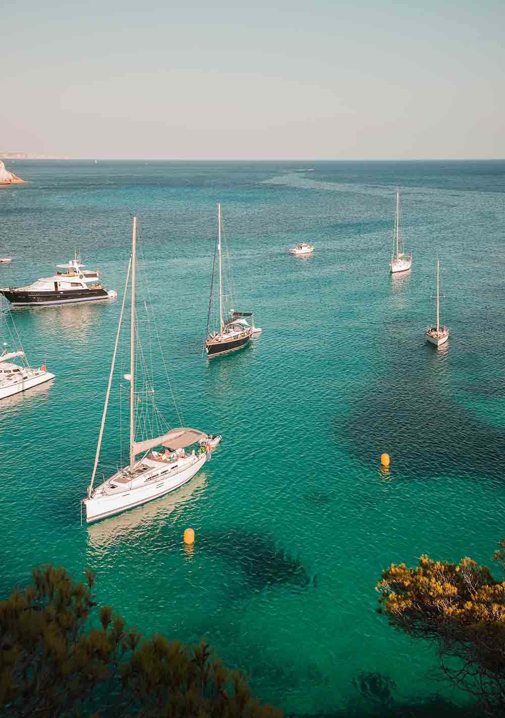 Yachts anchored in bay at Cala Macarella, Menorca, Spain